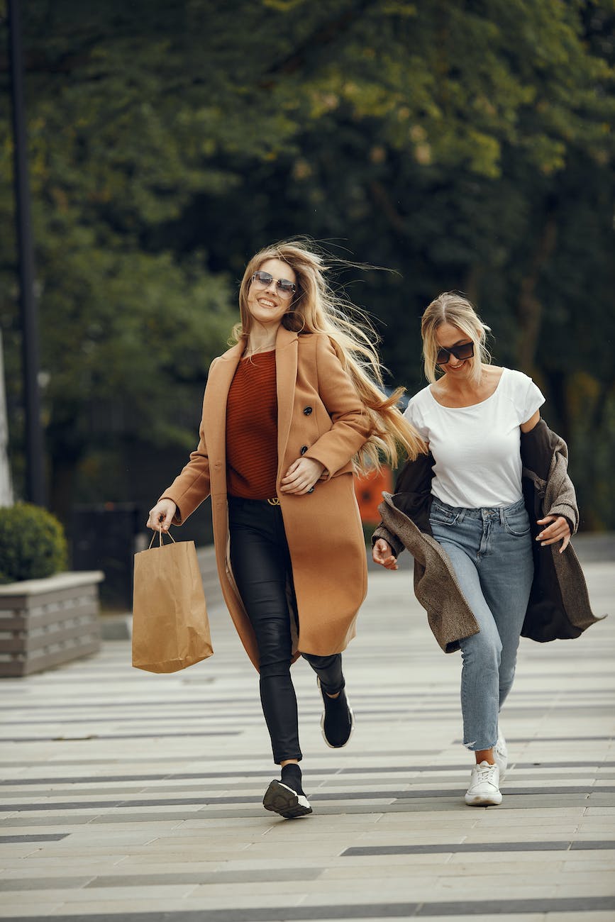 women in coats running