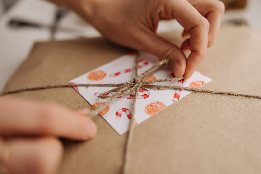 a close up shot of a person tying a jute rope